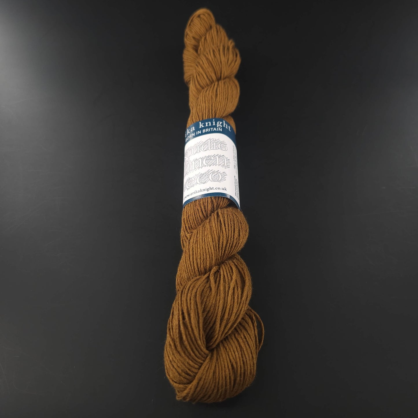 Echeveau de lin Studio Linen Eco d'Erika Knight de couleur 419 Souk (ocre) sur fond noir pour tricot et crochet.