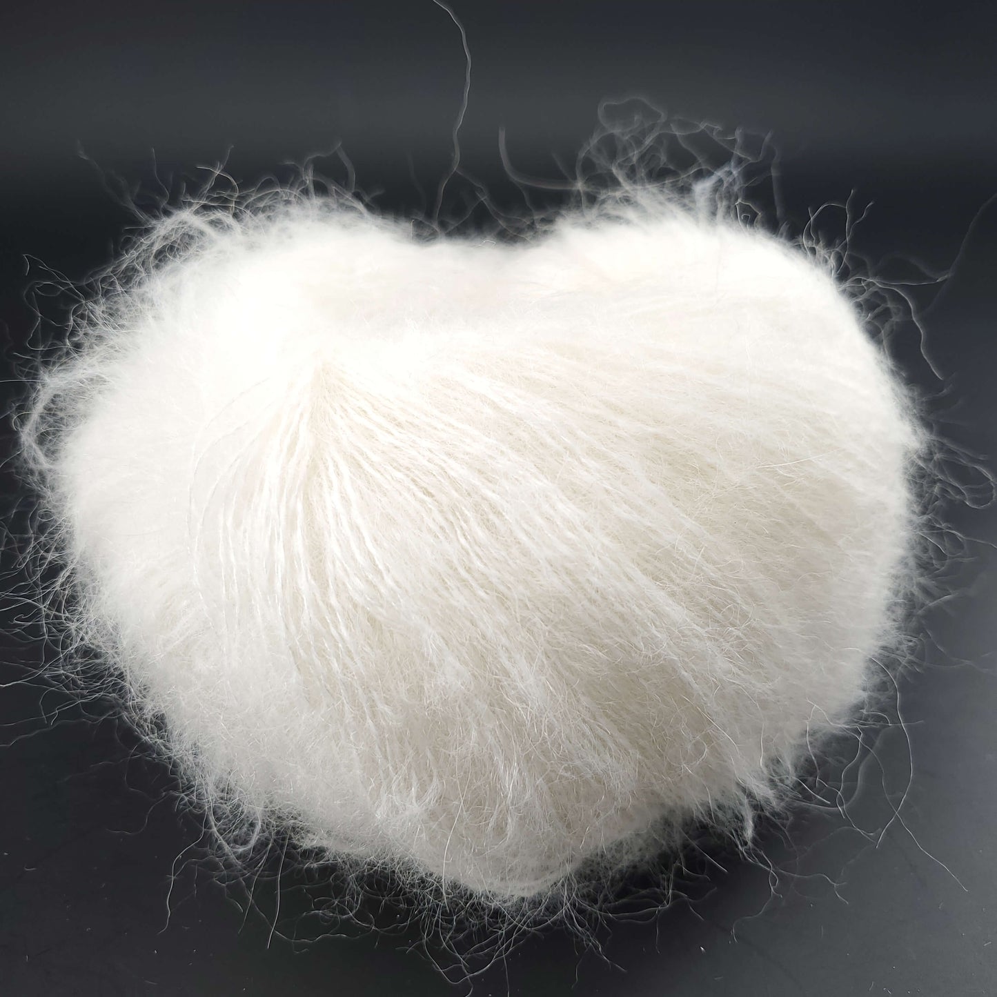 pelote de babysilk lace uni de marque kremke de coloris 2150 white pour tricot et crochet sur fond noir