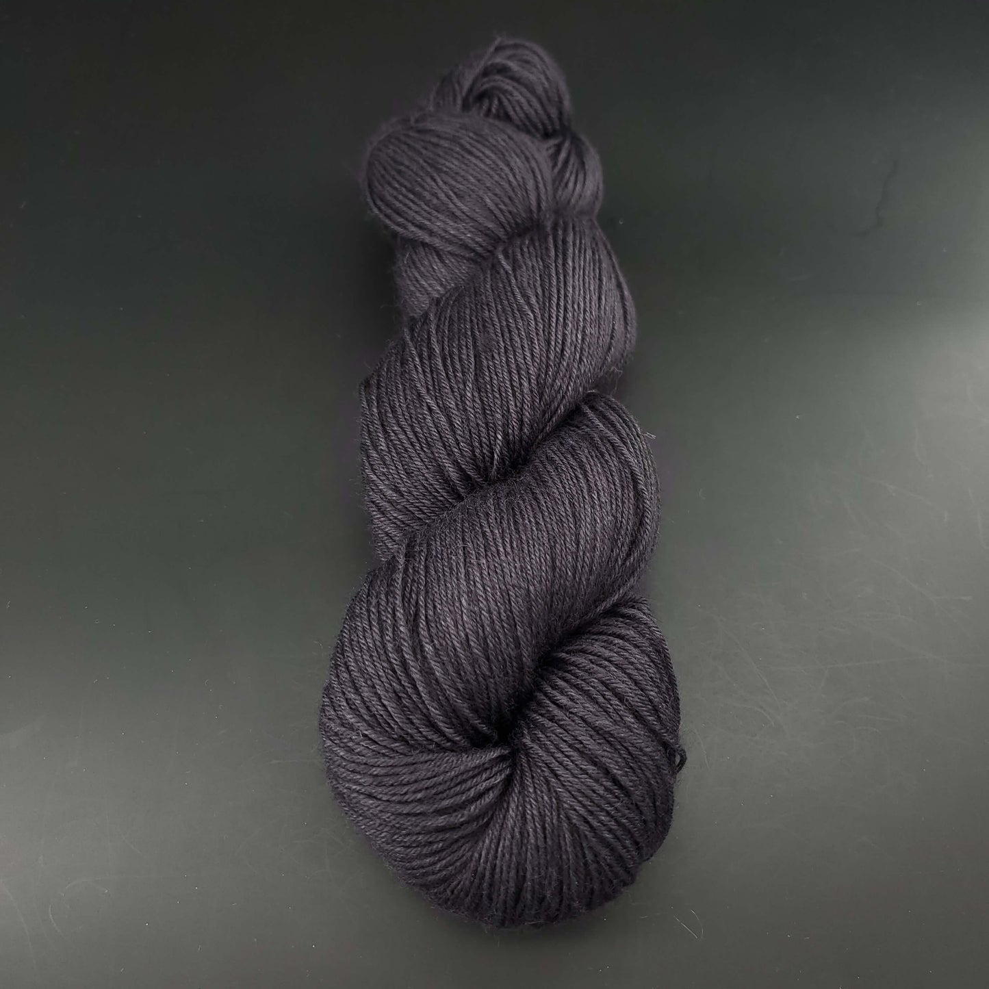 echeveau de laine merinos lazy lion unie de marque kremke de couleur anthracite pour tricot et crochet, sur fond noir