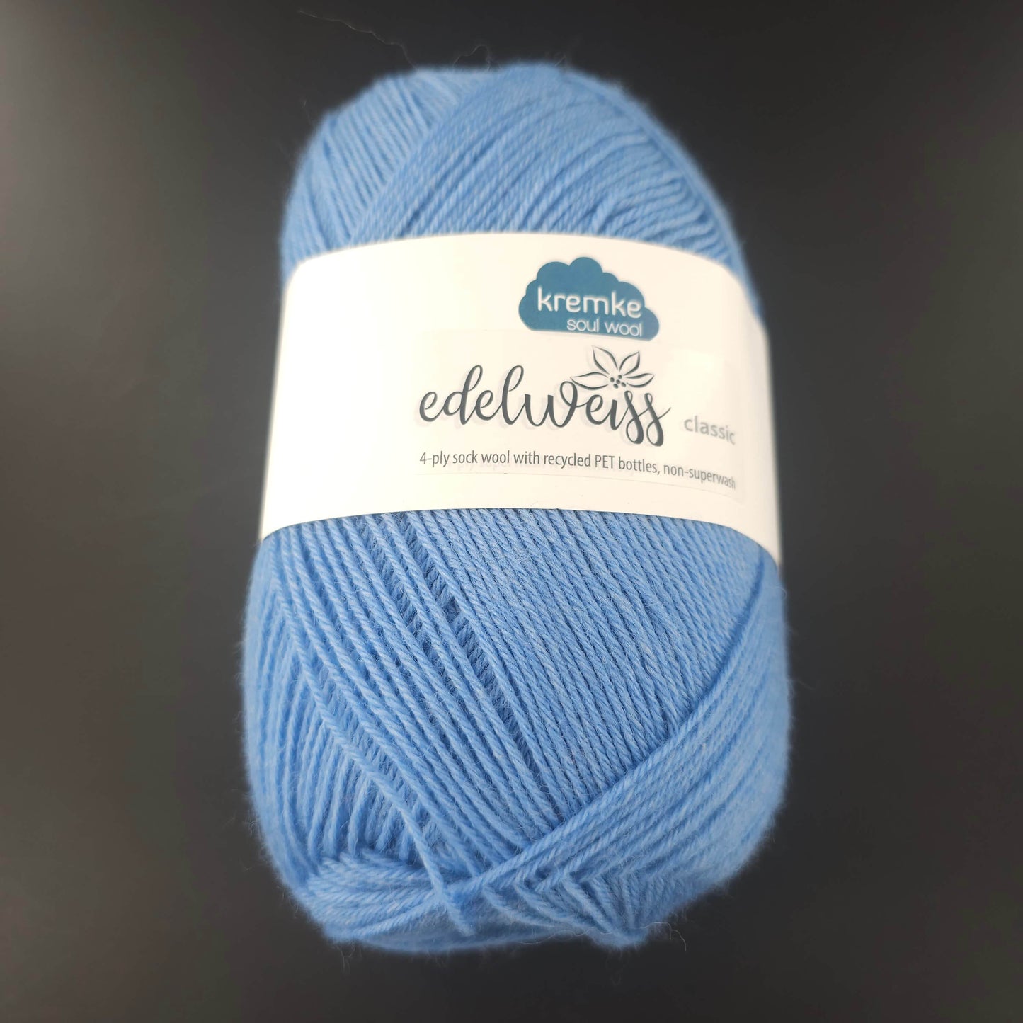pelote de laine edelweiss classic de marque kremke de coloris 405 bleu ciel pour tricot et crochet sur fond noir