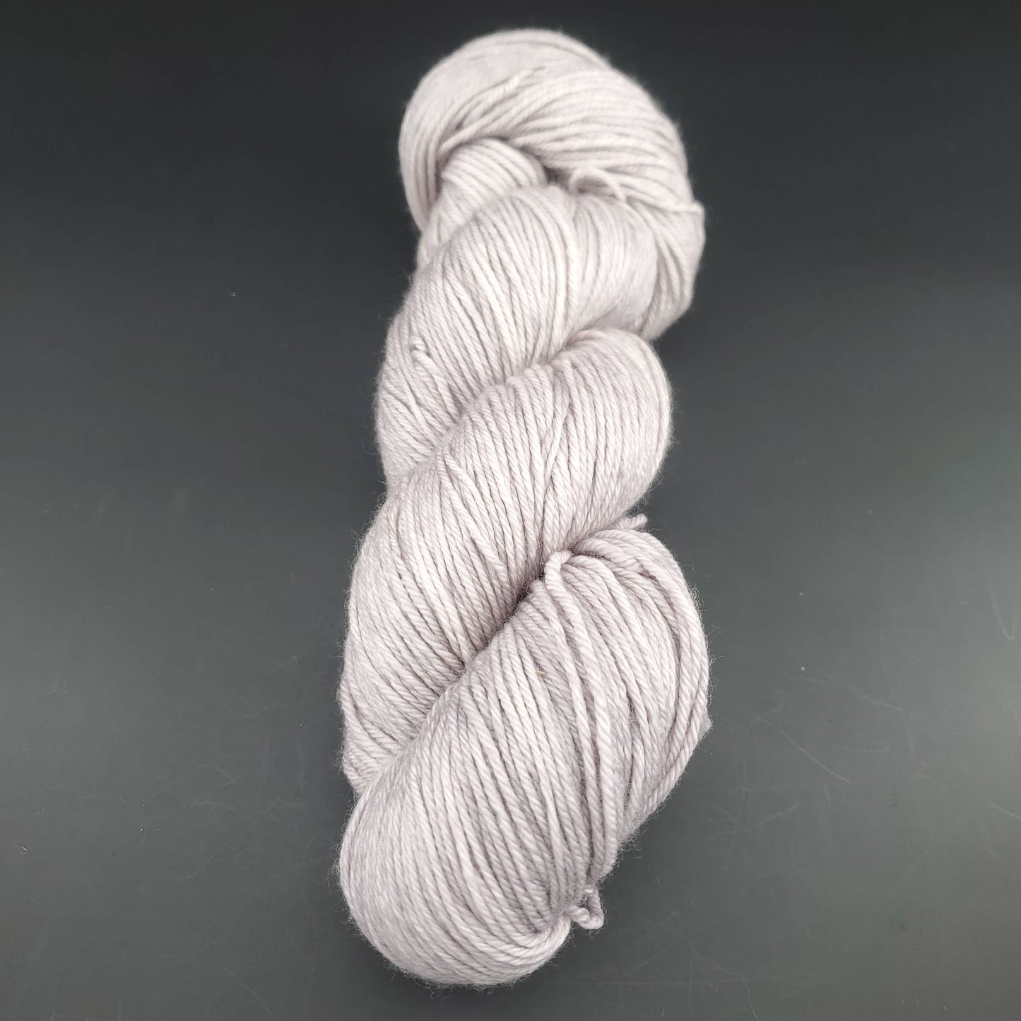 Echeveau de laine Malabrigo Arroyo de couleur 036 pearl sur fond noir pour tricot et crochet