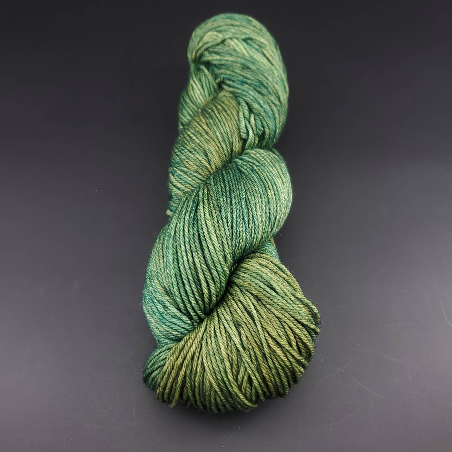 Echeveau de laine Malabrigo Arroyo de couleur 129 fresco y seco sur fond noir pour tricot et crochet