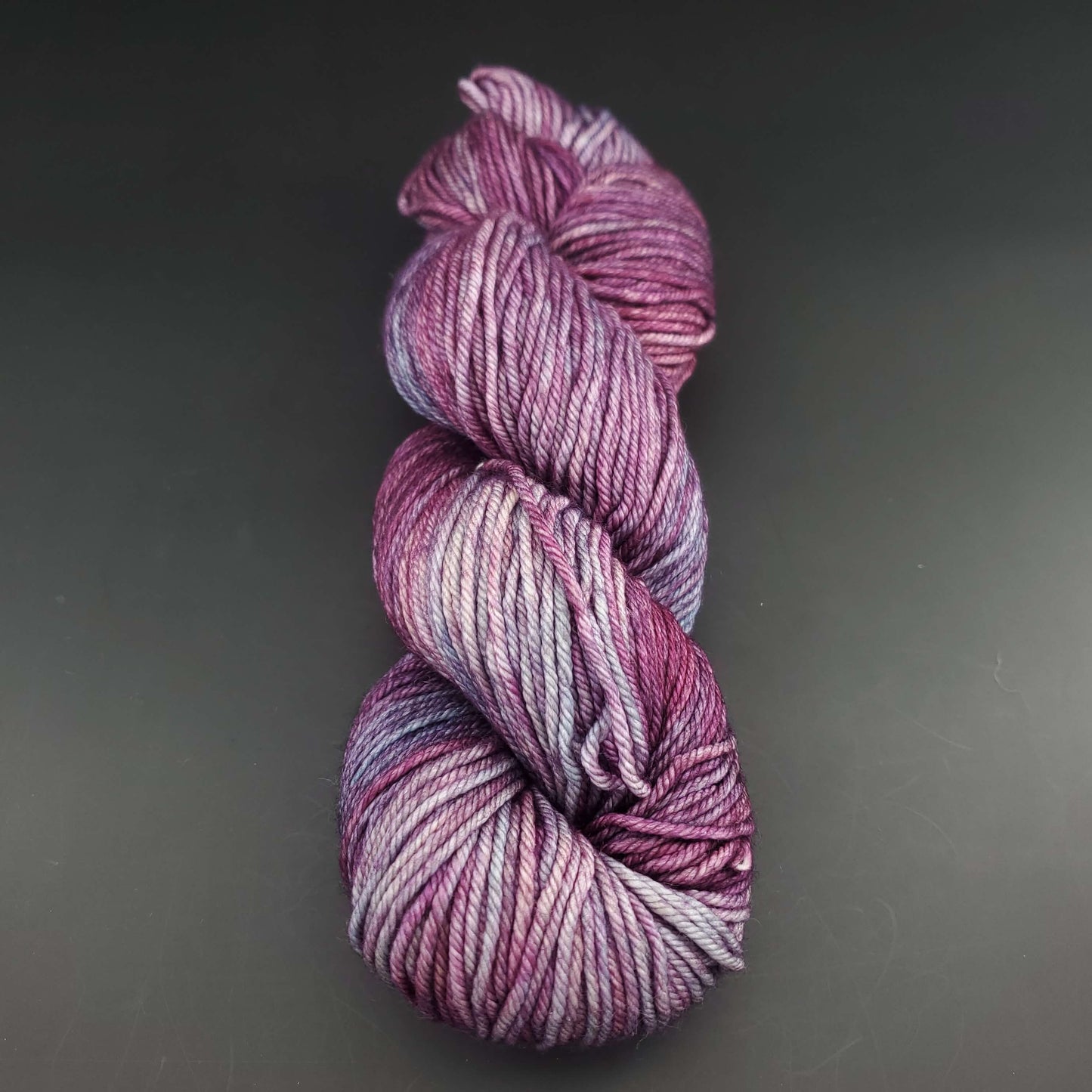 Echeveau de laine Malabrigo Rios de couleur 120 lotus sur fond noir pour tricot et crochet.