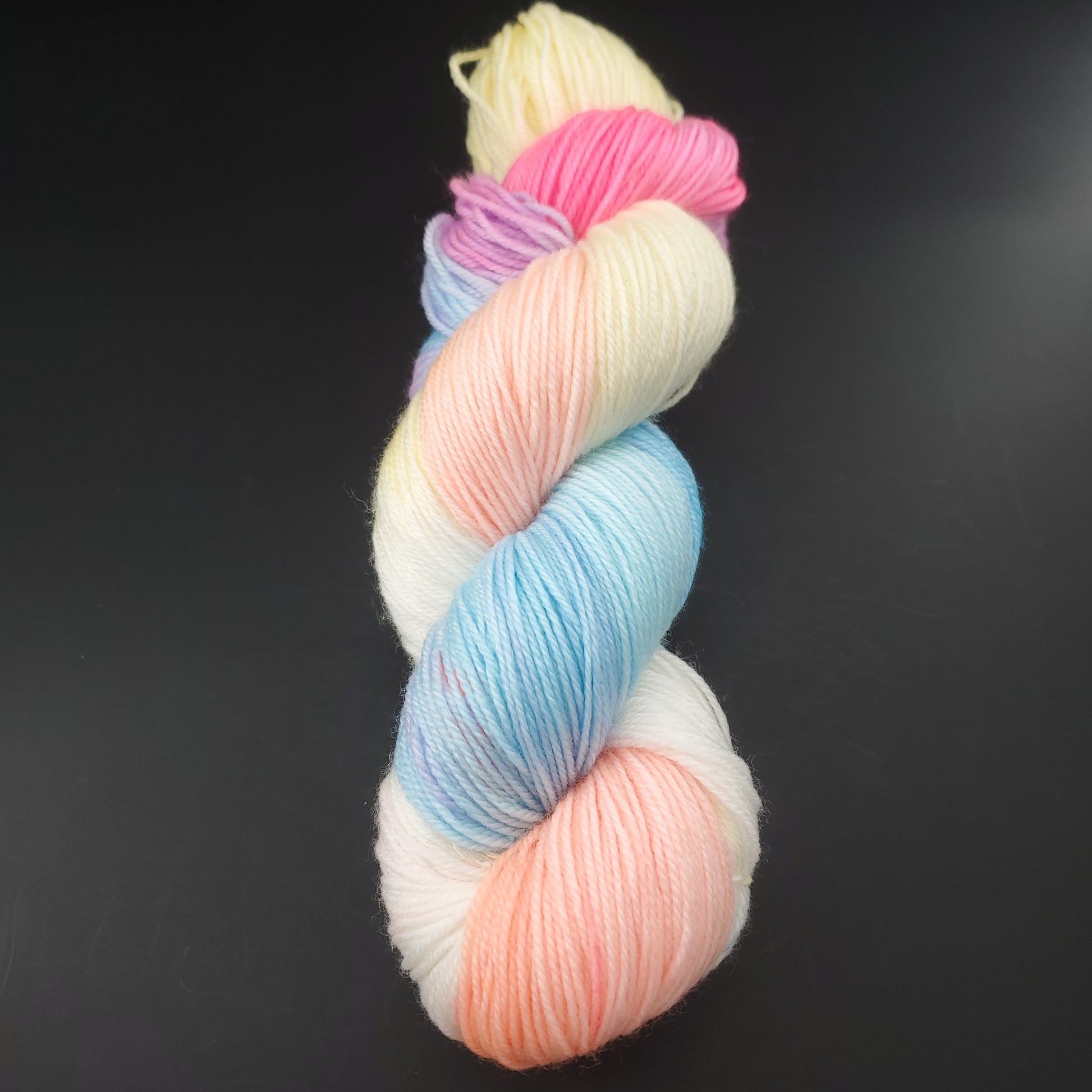 Echeveau de laine manos del uruguay de couleur 8730 macarons sur fond noir pour tricot et crochet.