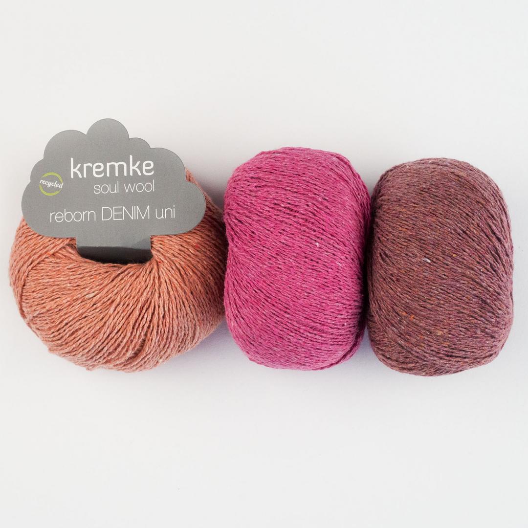 3 pelotes de fil à tricoter Reborn Denim Uni de Kremke en coton recyclé, orange, fushia et rose rouge